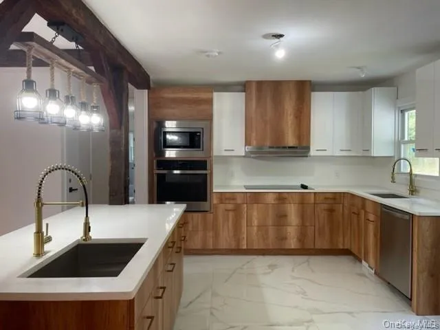 Kitchen featuring stainless steel appliances, white cabinets, sink, and light tile floors Kitchen featuring stainless steel appliances, white cabinets, sink, and light tile floors