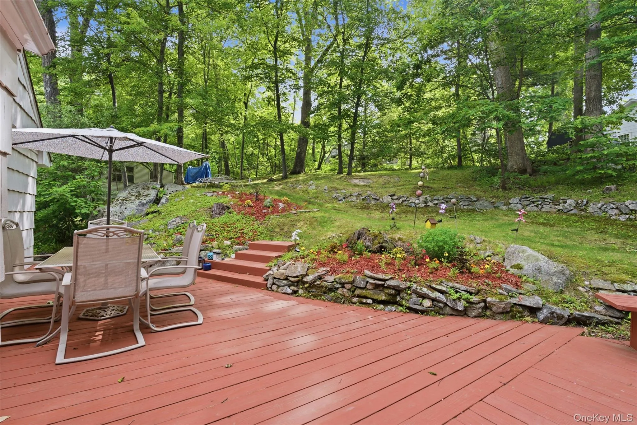 View of lush, nature-filled private yard from the deck View of lush, nature-filled private yard from the deck