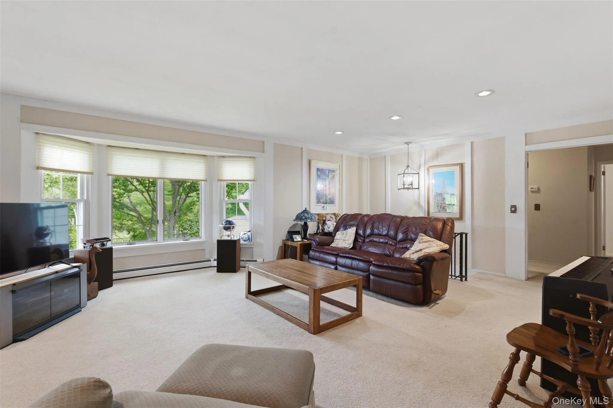Living room features picturesque windows Living room features picturesque windows