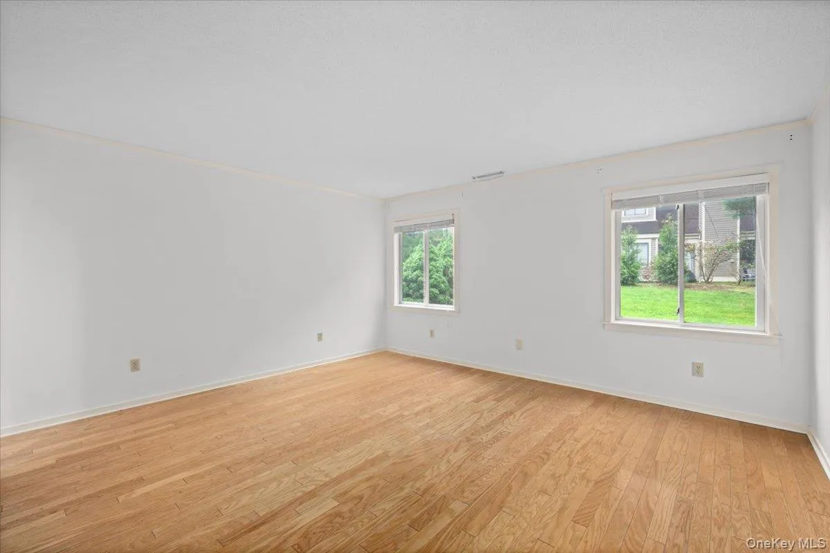 Main level primary bedroom with en suite, large closet, hardwood floors, and privacy Main level primary bedroom with en suite, large closet, hardwood floors, and privacy