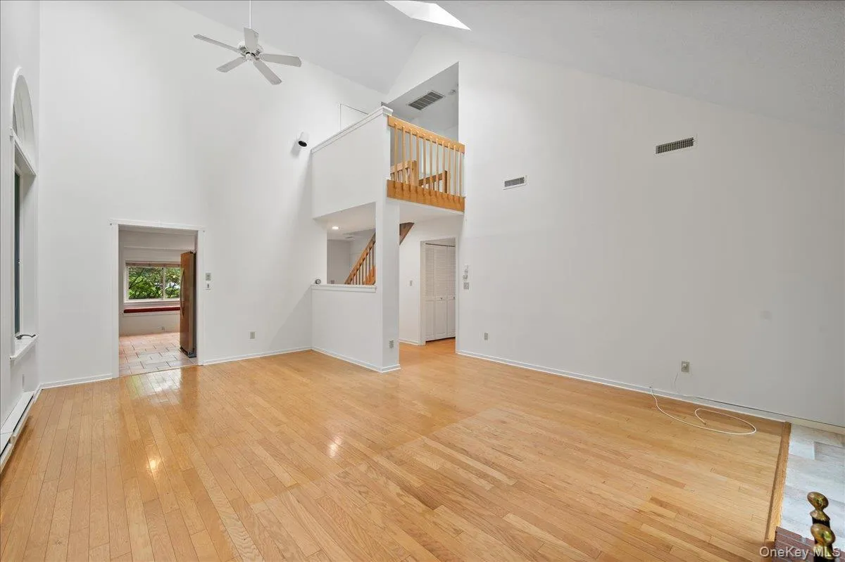 Living room with vaulted ceilings, large windows, and skylights Living room with vaulted ceilings, large windows, and skylights