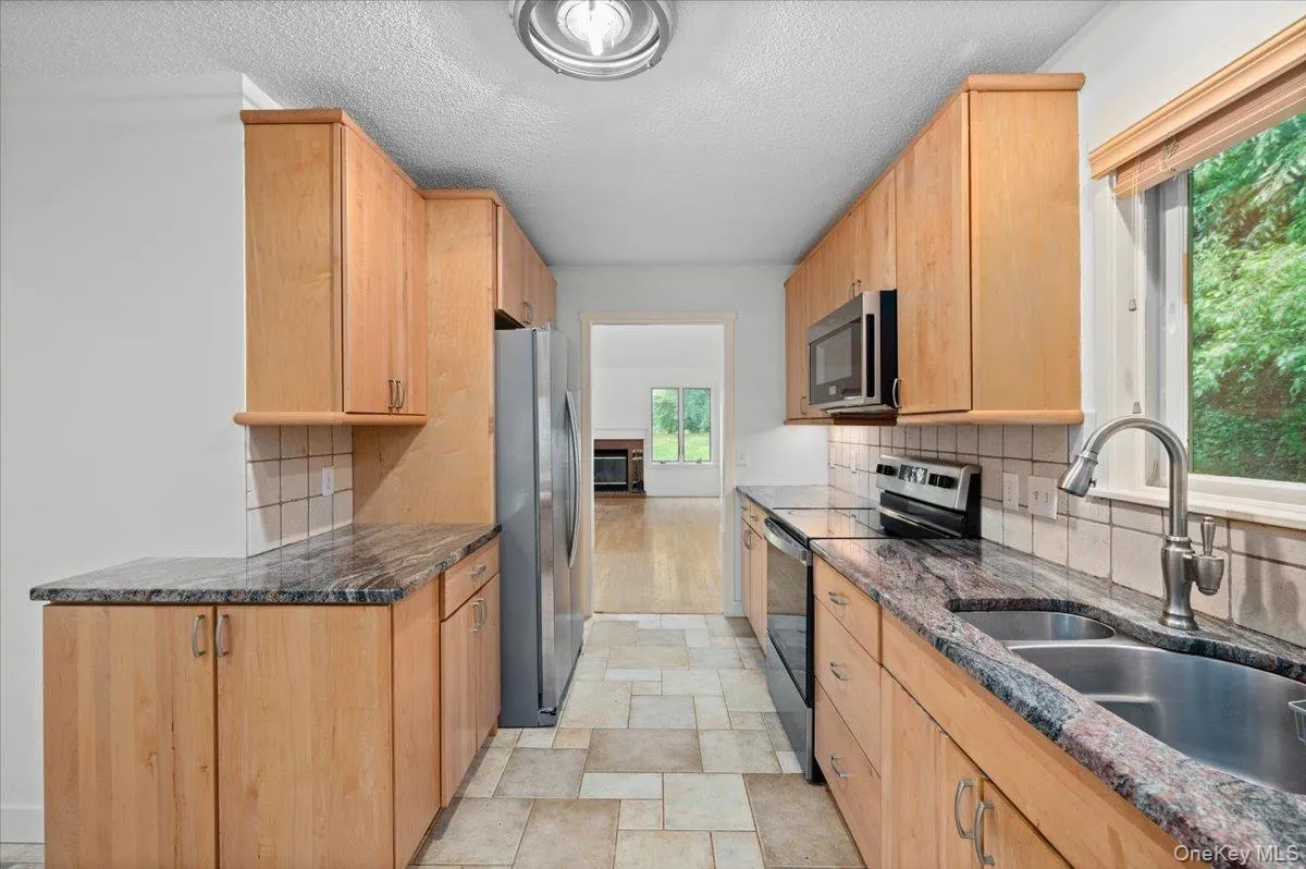 Walkthrough Kitchen with stainless steel appliances, cabinet underlighting, plenty of counter and cabinet space Walkthrough Kitchen with stainless steel appliances, cabinet underlighting, plenty of counter and cabinet space