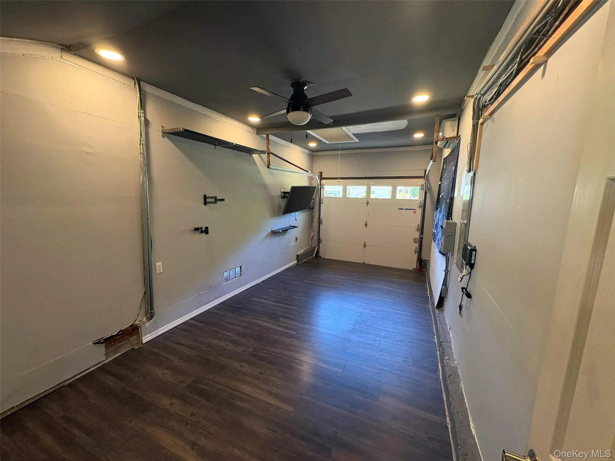 Finished interior space featuring wood-finish flooring, recessed lighting, and a ceiling fan Finished interior space featuring wood-finish flooring, recessed lighting, and a ceiling fan