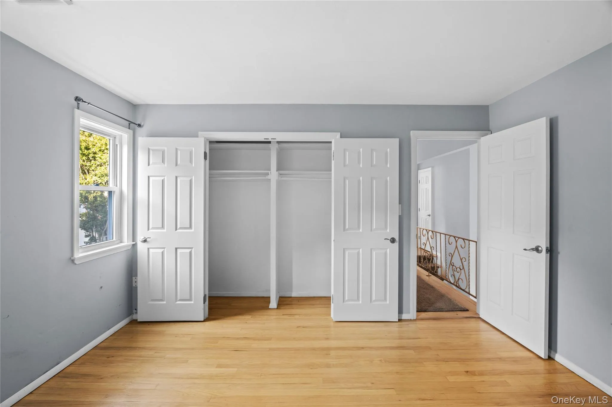 Light wood-finish flooring complemented by light gray walls Light wood-finish flooring complemented by light gray walls