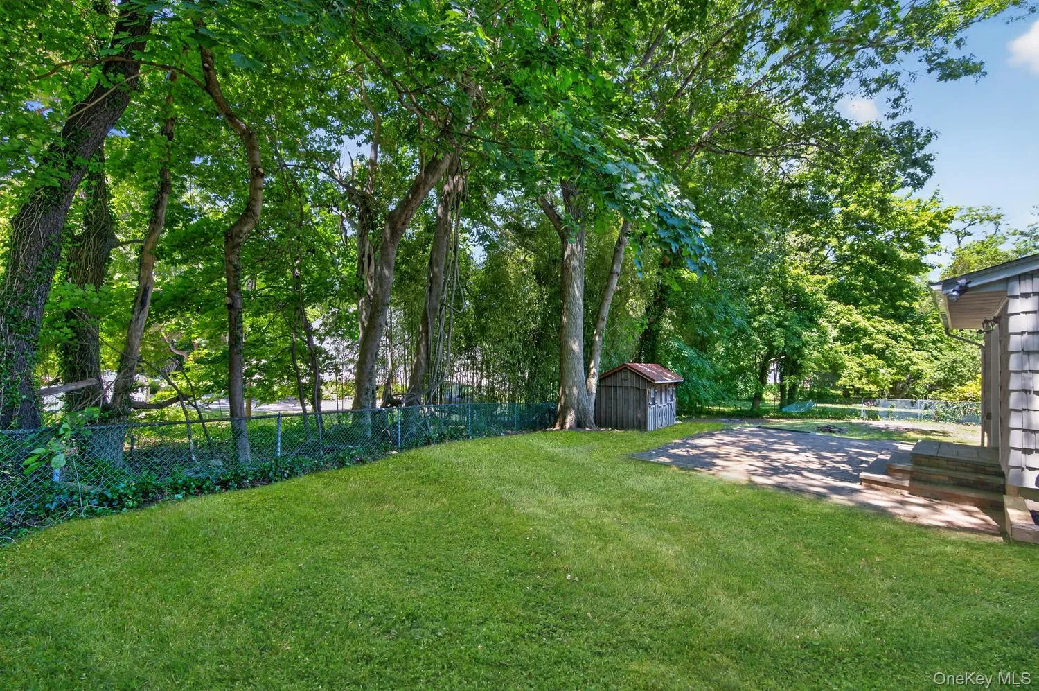 Back Yard Is Made Private By Mature Trees. Grass Is Digitally Enhanced. Back Yard Is Made Private By Mature Trees. Grass Is Digitally Enhanced.