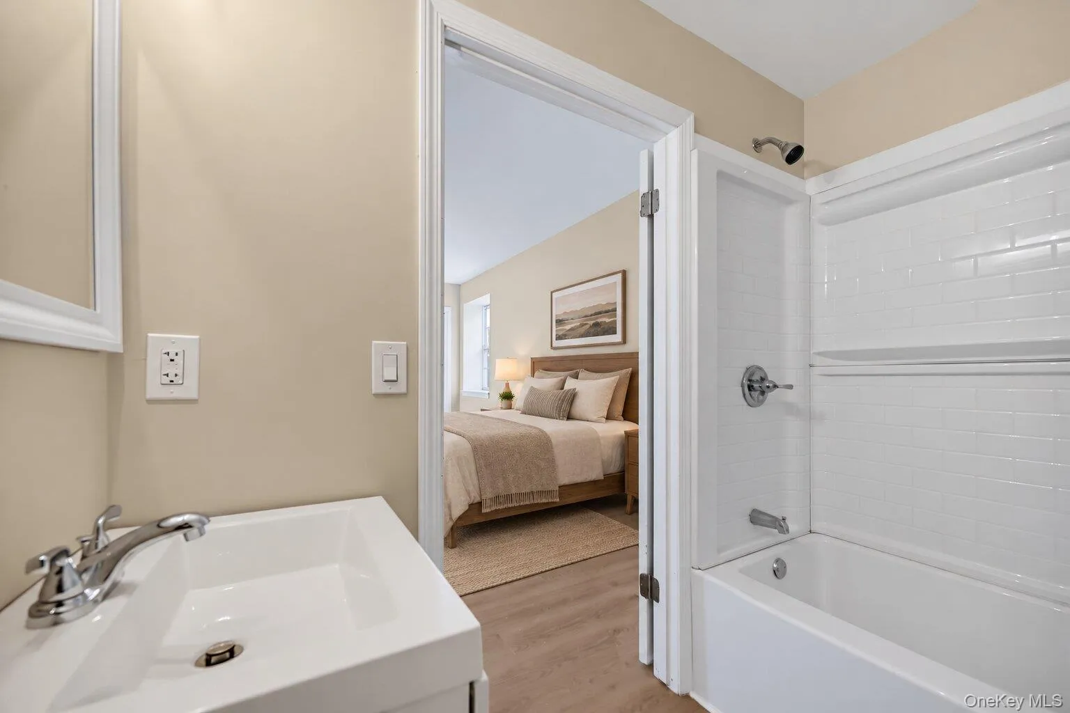 Virtually Staged bedroom. bathroom with a tub/shower combination, white vanity, and direct access to the primary bedroom. Virtually Staged bedroom. bathroom with a tub/shower combination, white vanity, and direct access to the primary bedroom.