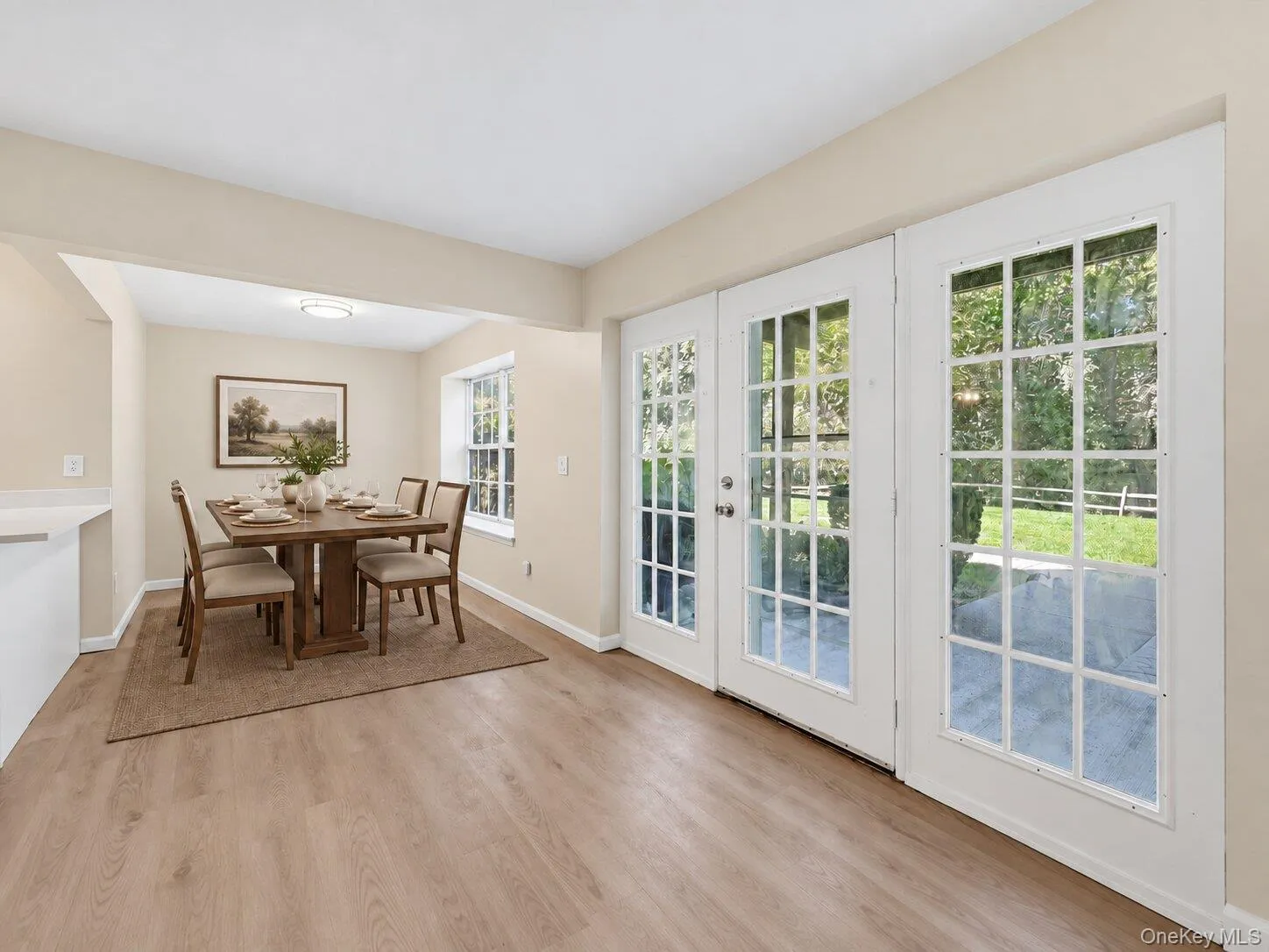 Virtually Staged. Open dining area with French doors providing abundant natural light and access to the outdoor patio. Virtually Staged. Open dining area with French doors providing abundant natural light and access to the outdoor patio.