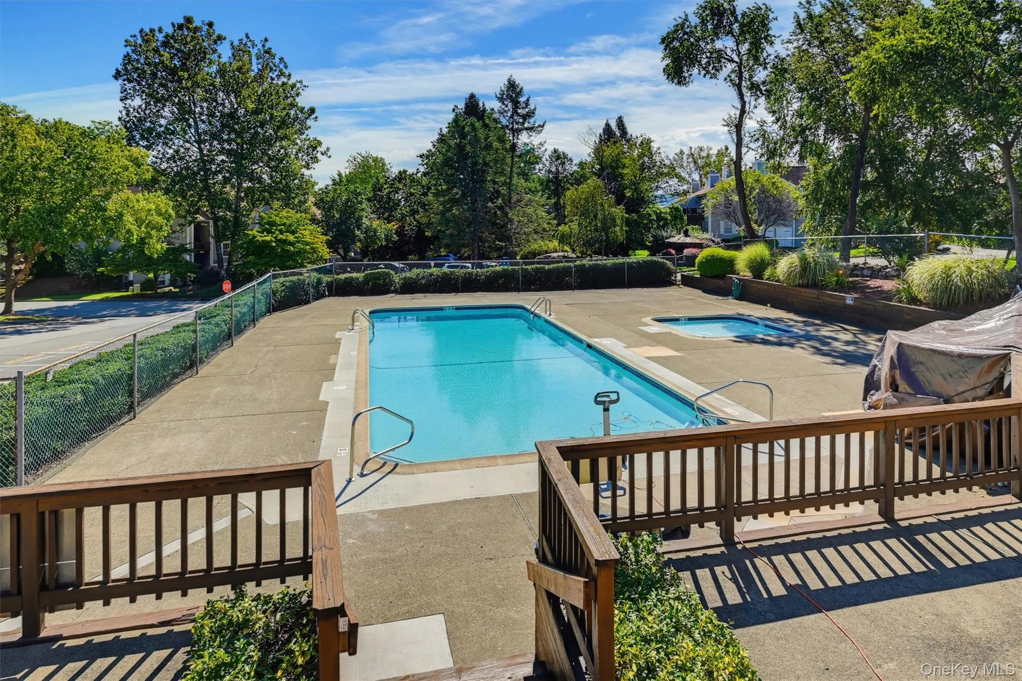 Community swimming pool with separate shallow pool area and surrounding deck space. Community swimming pool with separate shallow pool area and surrounding deck space.