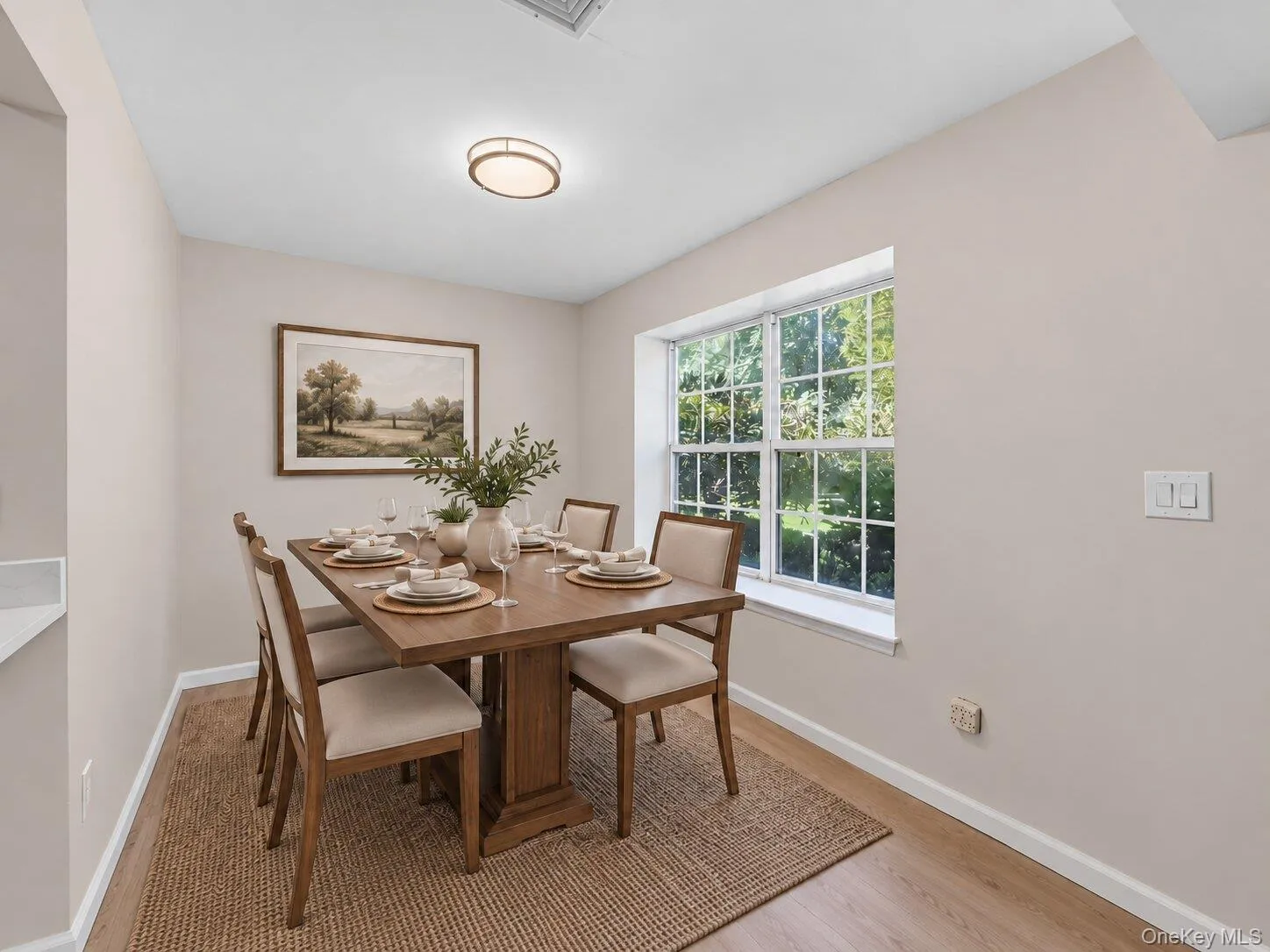 Virtually Staged. Dining area with large window, light wood flooring, and space for a full-size dining table. Virtually Staged. Dining area with large window, light wood flooring, and space for a full-size dining table.