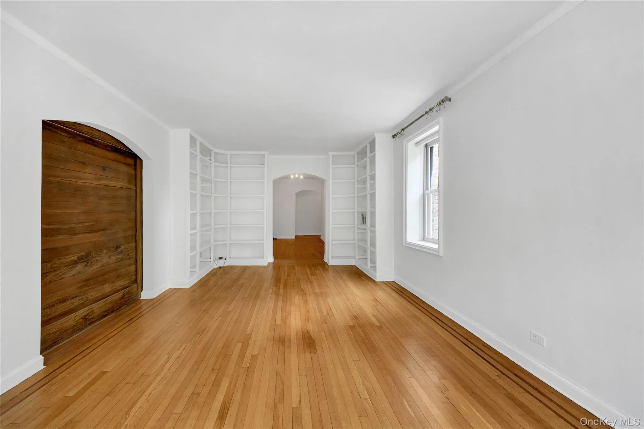 View of the living room, w/ barn door closed, for a private main bedroom. The barn door doubles as a beautiful accent living room wall. View of the living room, w/ barn door closed, for a private main bedroom. The barn door doubles as a beautiful accent living room wall.