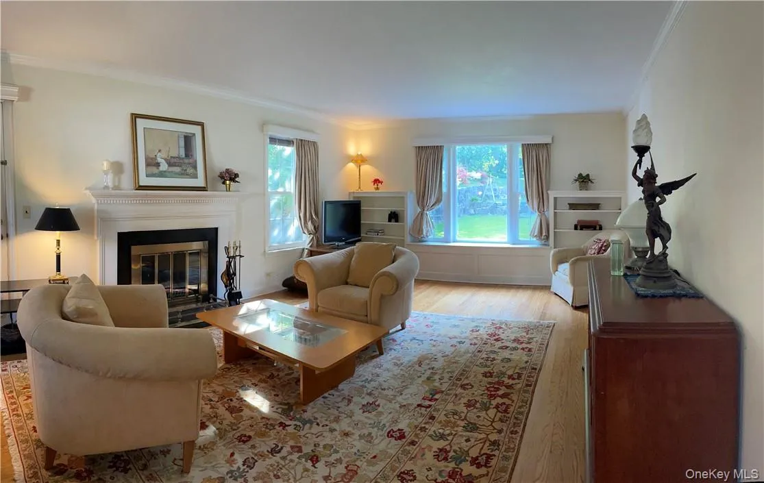 View of the formal living room with bay window and wood burning fireplace View of the formal living room with bay window and wood burning fireplace