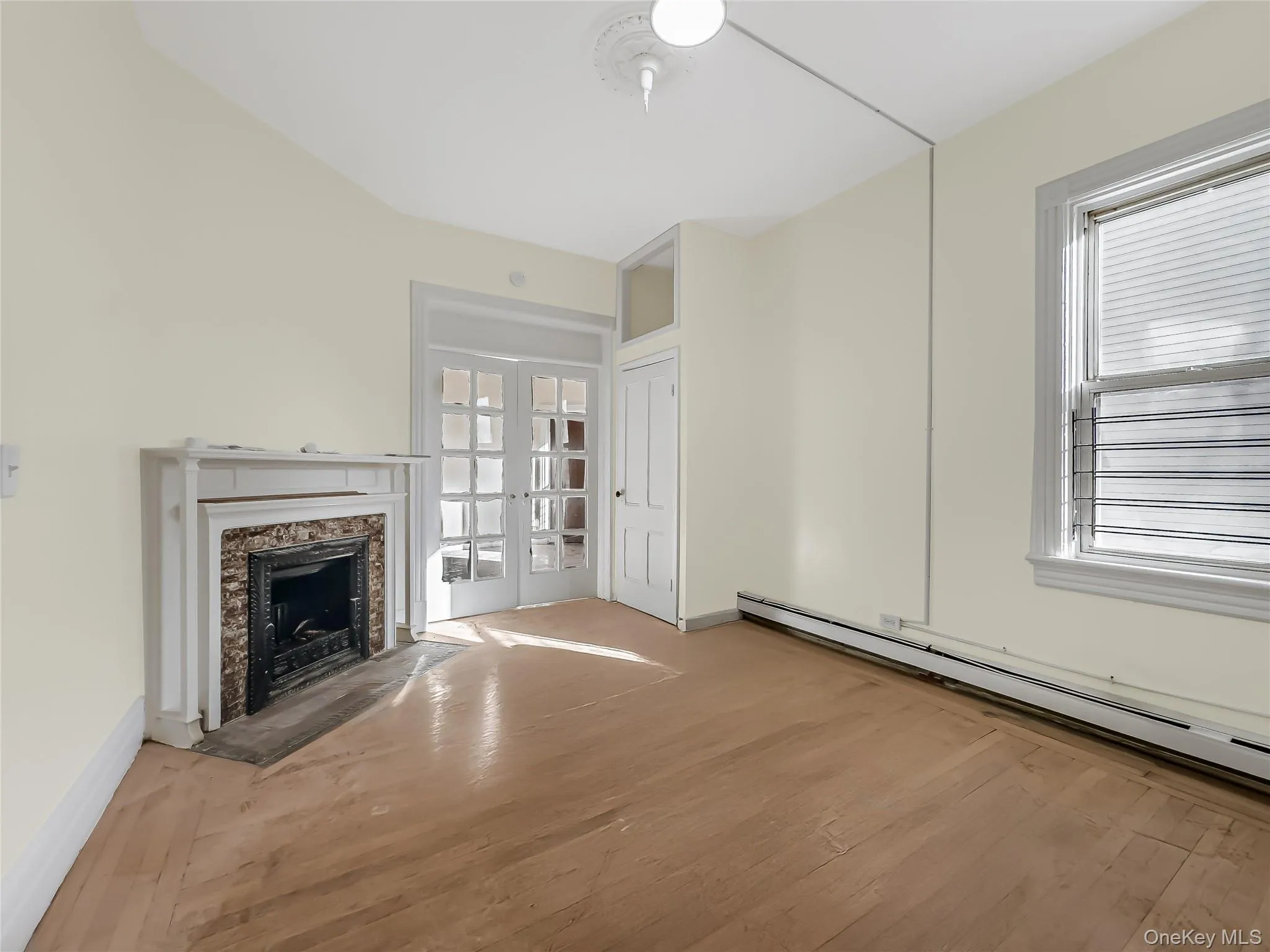 2nd angle of primary bedroom with decorative fireplace 2nd angle of primary bedroom with decorative fireplace