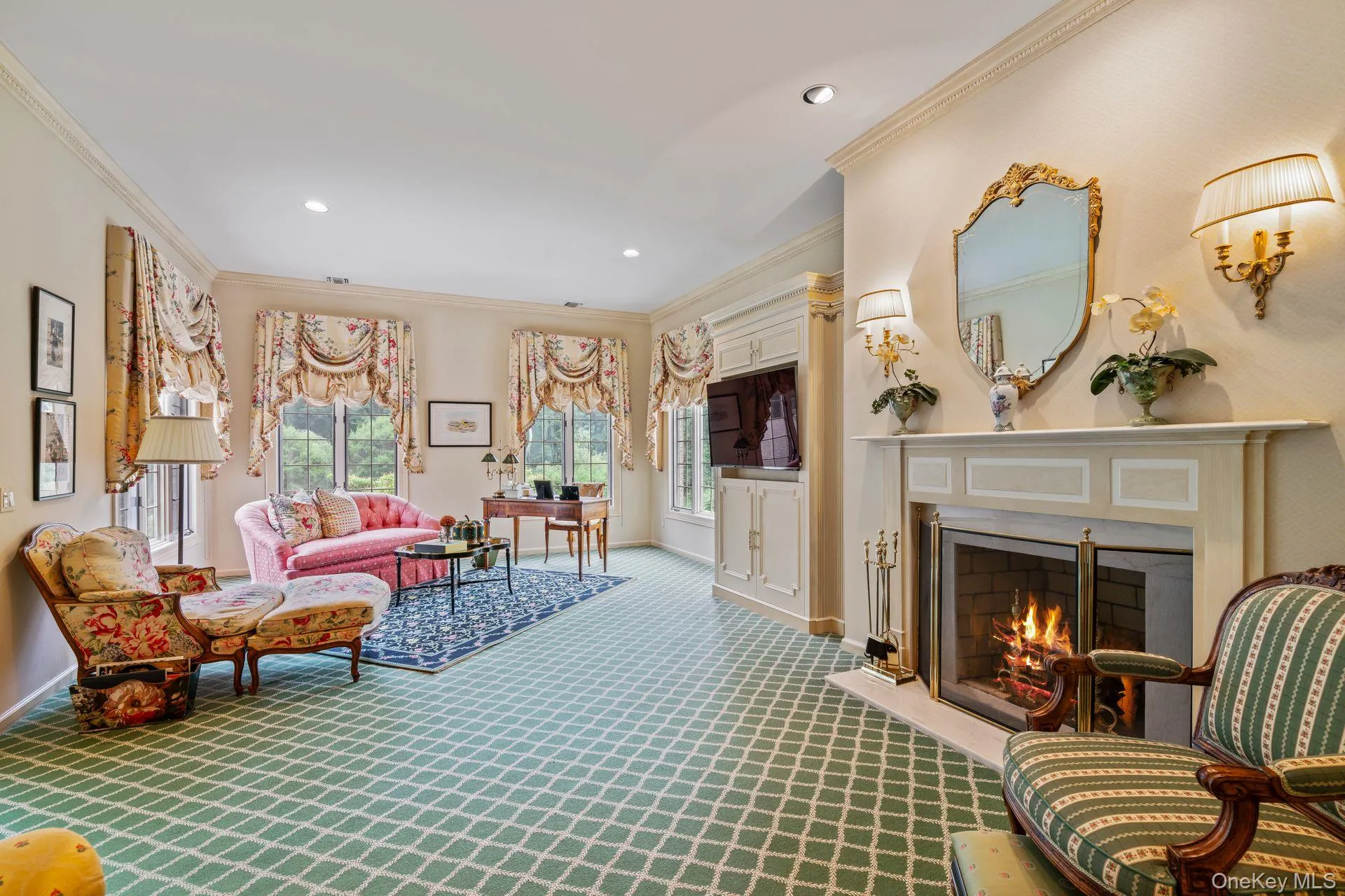 Spacious sitting room with plenty of natural light, crown molding, gas fireplace and recessed lighting Spacious sitting room with plenty of natural light, crown molding, gas fireplace and recessed lighting