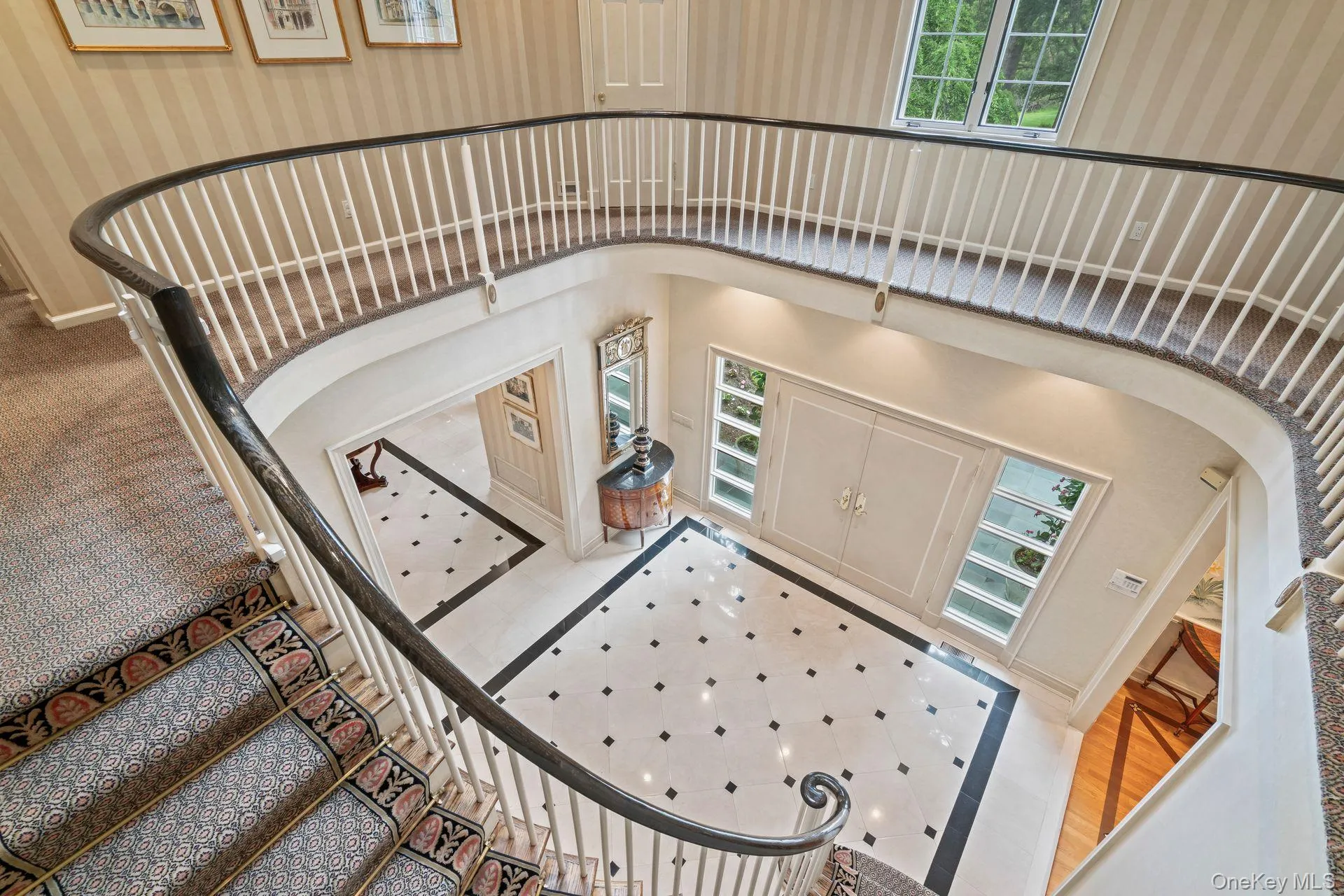 Sweeping staircase to stunning curved hallway creates architectural focal point Sweeping staircase to stunning curved hallway creates architectural focal point