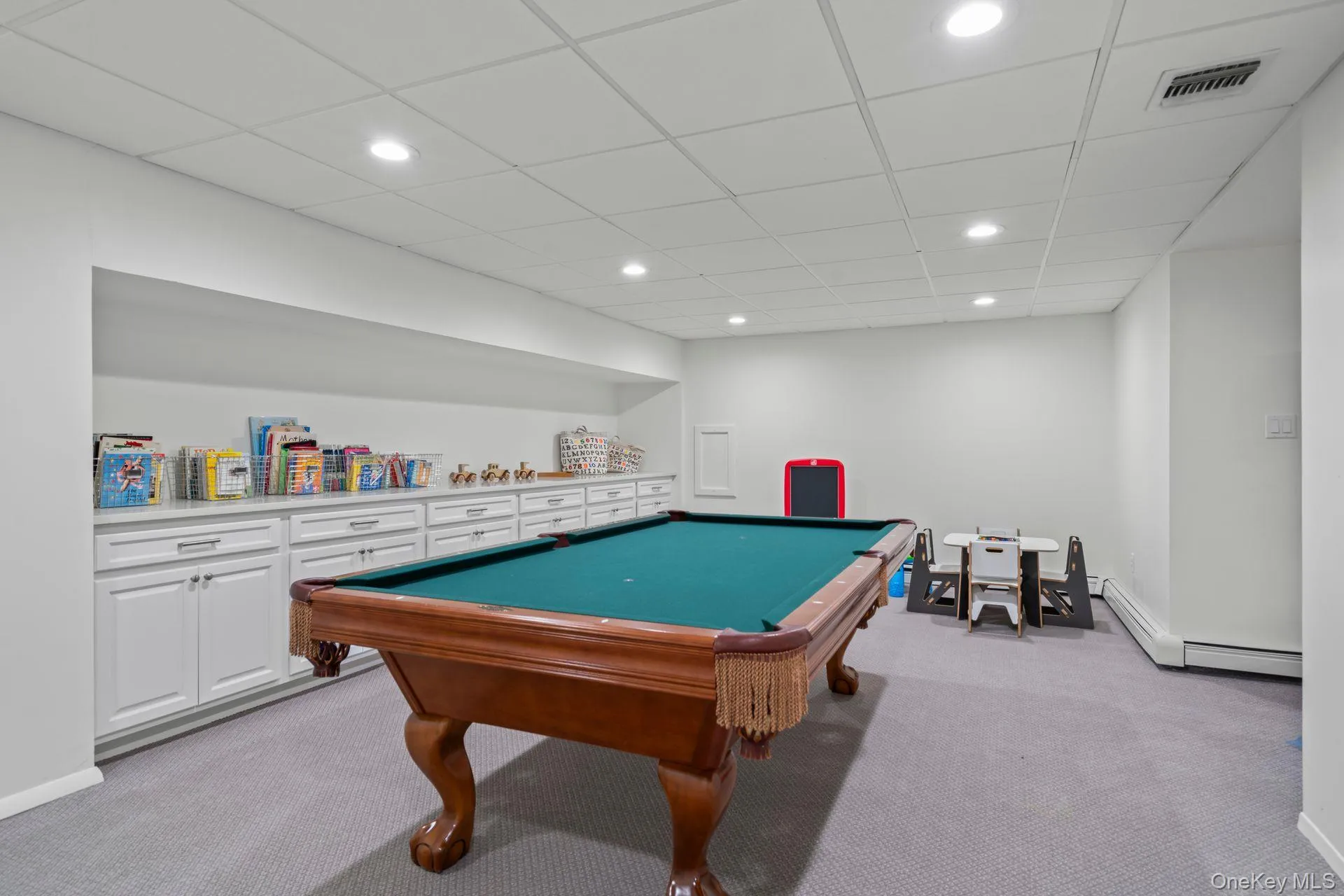 One of many Lowe level playrooms, this one with wall of built in cabinets, light colored carpet, abundance of large storage closets One of many Lowe level playrooms, this one with wall of built in cabinets, light colored carpet, abundance of large storage closets