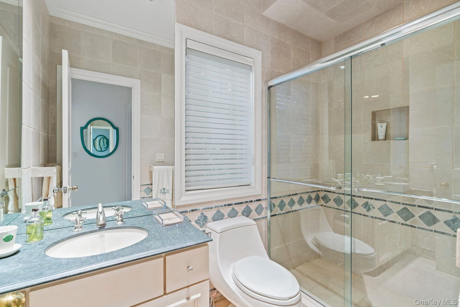 Full bathroom featuring tile walls, vanity, and a stall shower Full bathroom featuring tile walls, vanity, and a stall shower