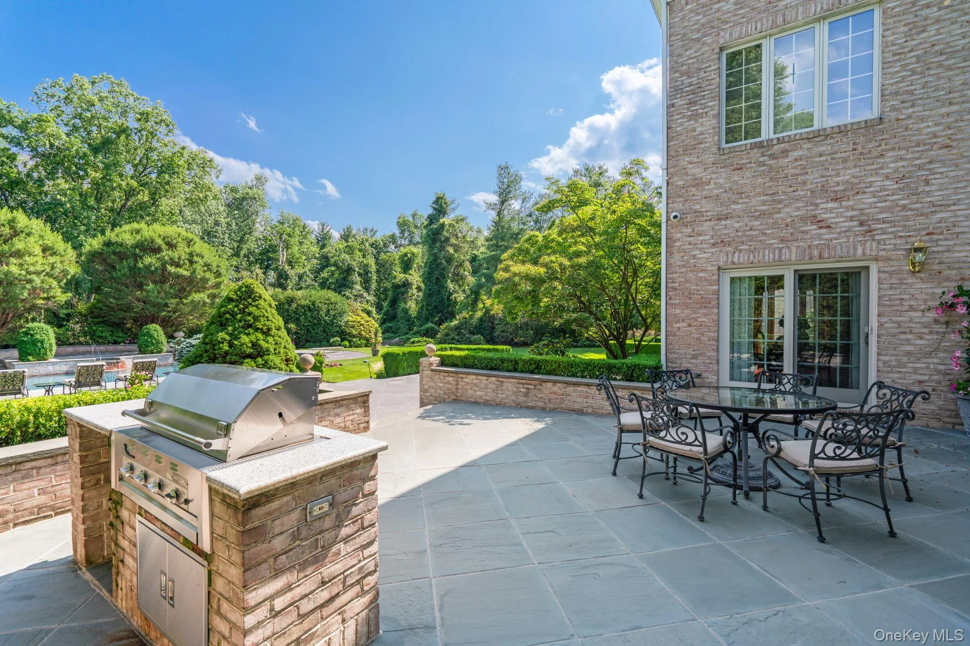 View of patio featuring built-in BBQ and outdoor dining space View of patio featuring built-in BBQ and outdoor dining space