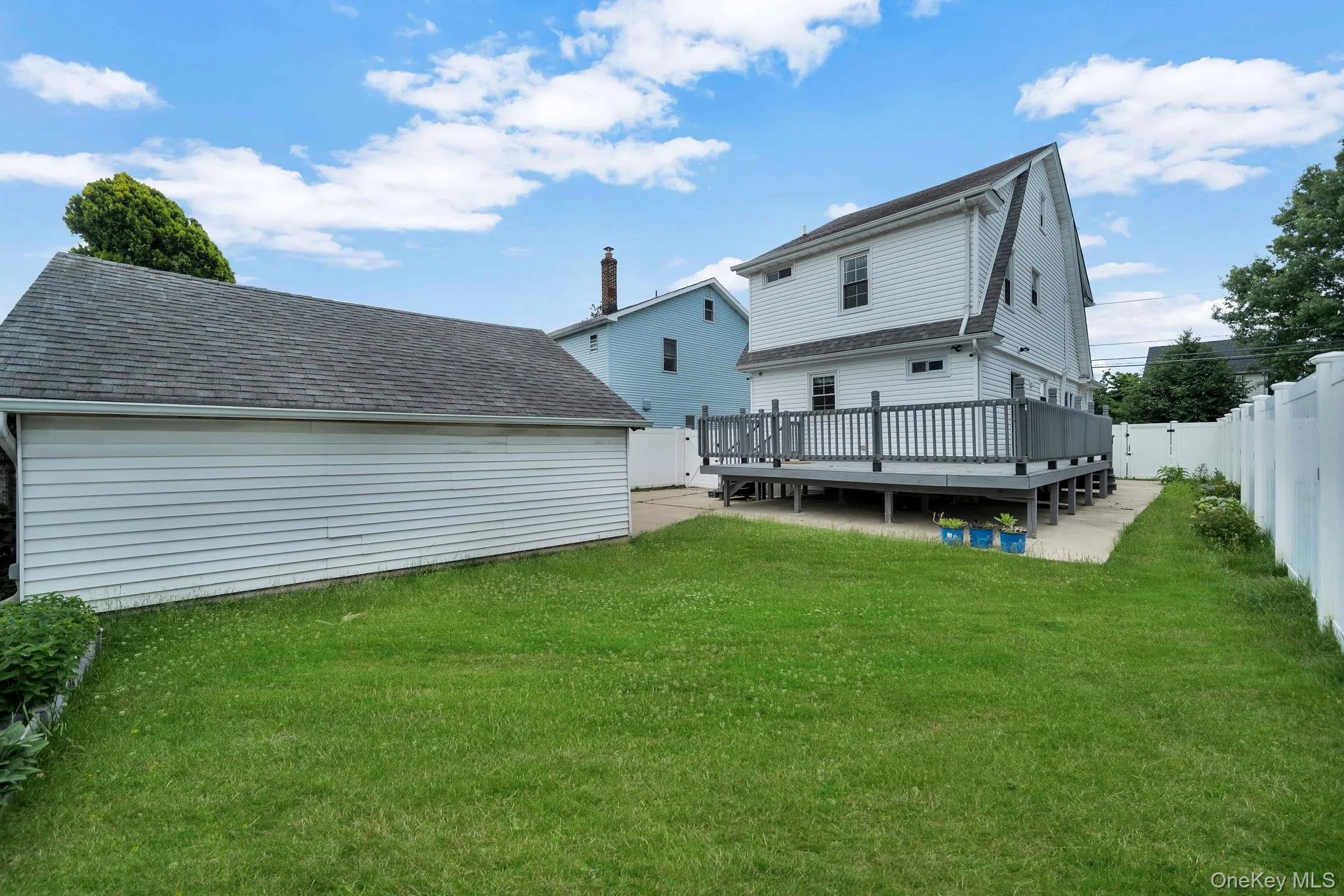 Backyard along with wooden deck. Backyard along with wooden deck.
