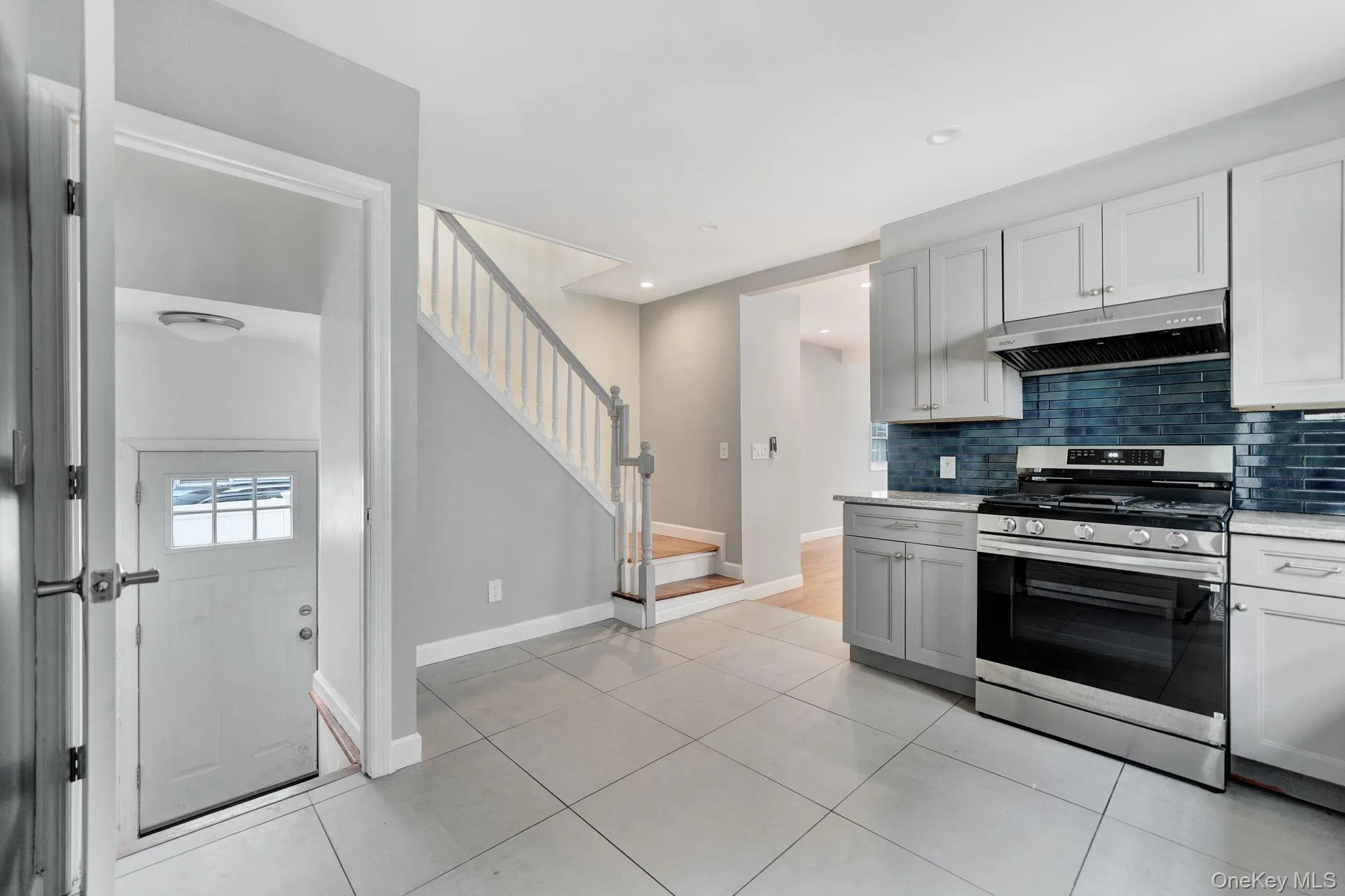 Kitchen and door to basement and driveway. Kitchen and door to basement and driveway.