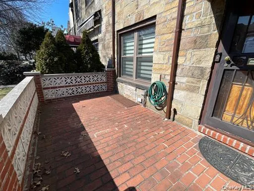 Brick paver patio featuring a decorative stone and brick railing Brick paver patio featuring a decorative stone and brick railing