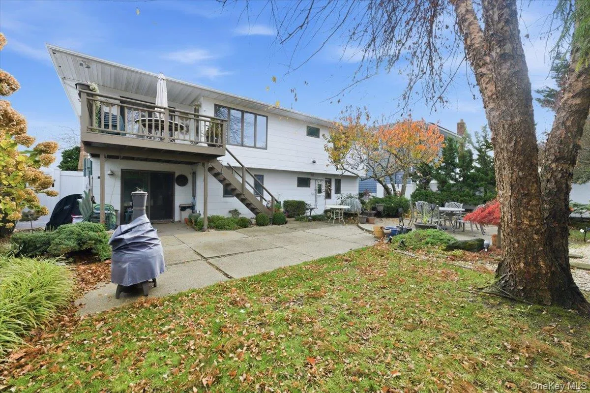 Back of property with a patio area, stairway, and a deck Back of property with a patio area, stairway, and a deck