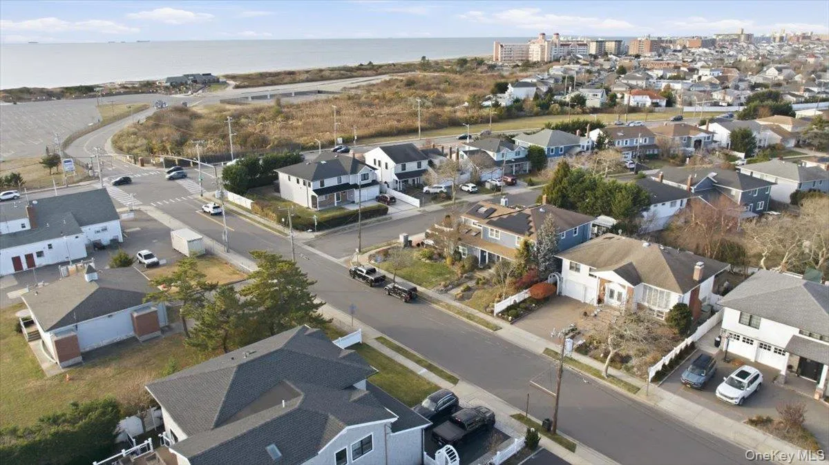 Aerial view of residential area featuring a nearby body of water Aerial view of residential area featuring a nearby body of water