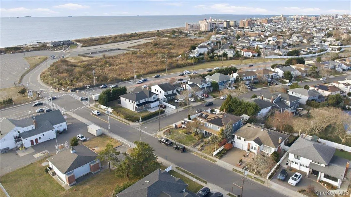 Aerial overview of property's location with nearby suburban area and a large body of water Aerial overview of property's location with nearby suburban area and a large body of water