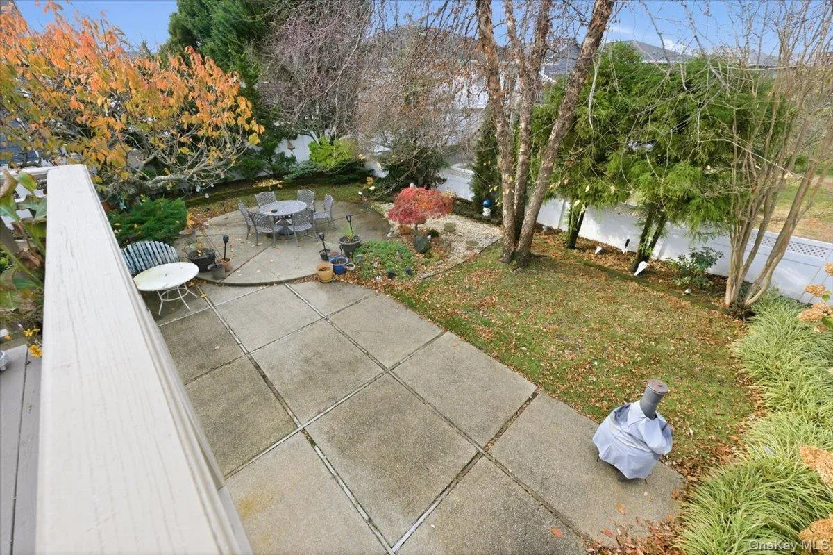 View of green lawn with a patio area and outdoor dining space View of green lawn with a patio area and outdoor dining space