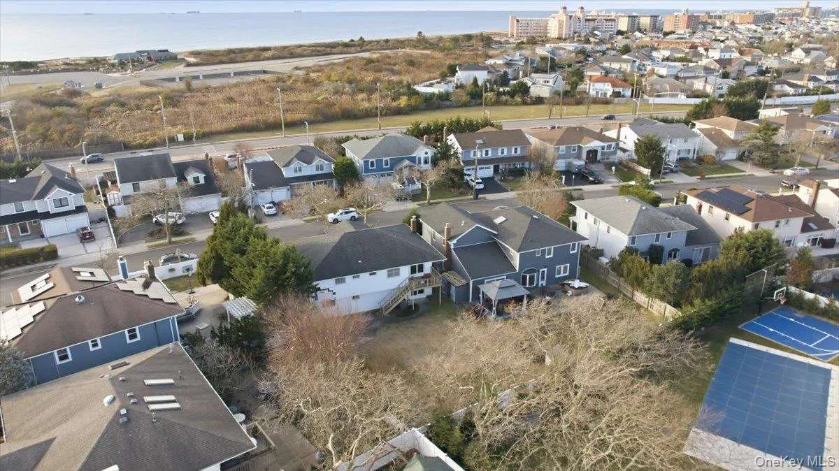 Aerial perspective of suburban area with a large body of water Aerial perspective of suburban area with a large body of water