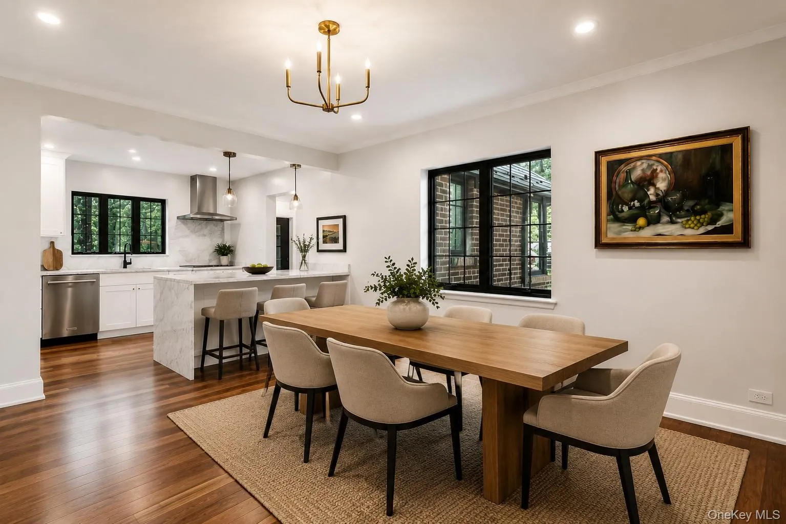 Spacious dining area featuring wood-finish flooring, a contemporary chandelier, and a large window with black grilles Spacious dining area featuring wood-finish flooring, a contemporary chandelier, and a large window with black grilles