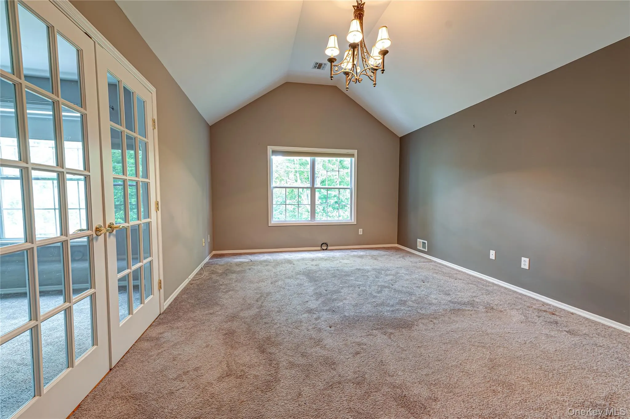 Primary Bedroom with French glass doors to an adjoining room Primary Bedroom with French glass doors to an adjoining room