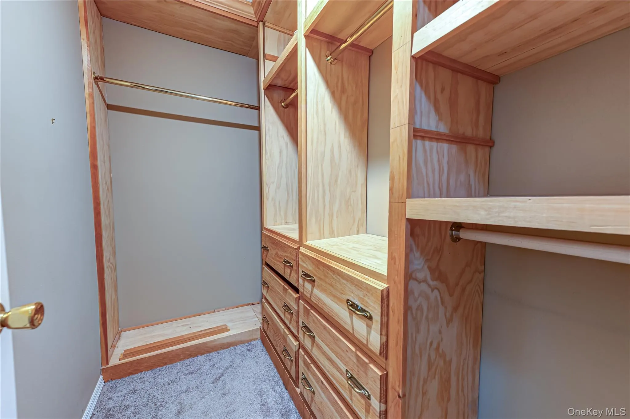 Primary Bedroom Closet with custom built shelves and drawers Primary Bedroom Closet with custom built shelves and drawers