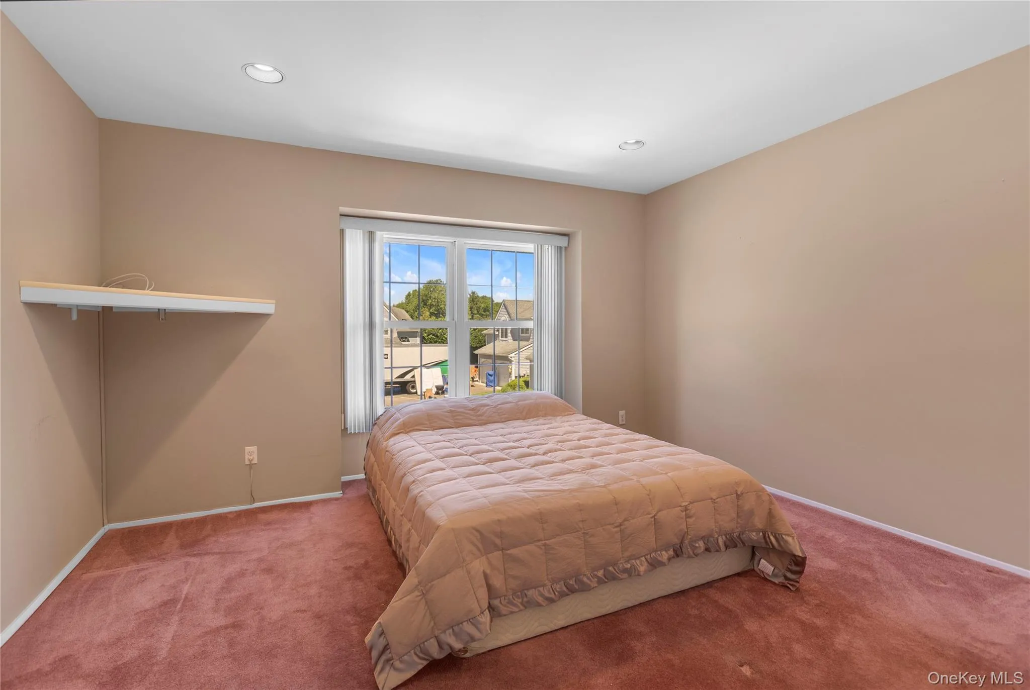 Carpeted room featuring a large window, neutral wall paint, and recessed ceiling lighting Carpeted room featuring a large window, neutral wall paint, and recessed ceiling lighting