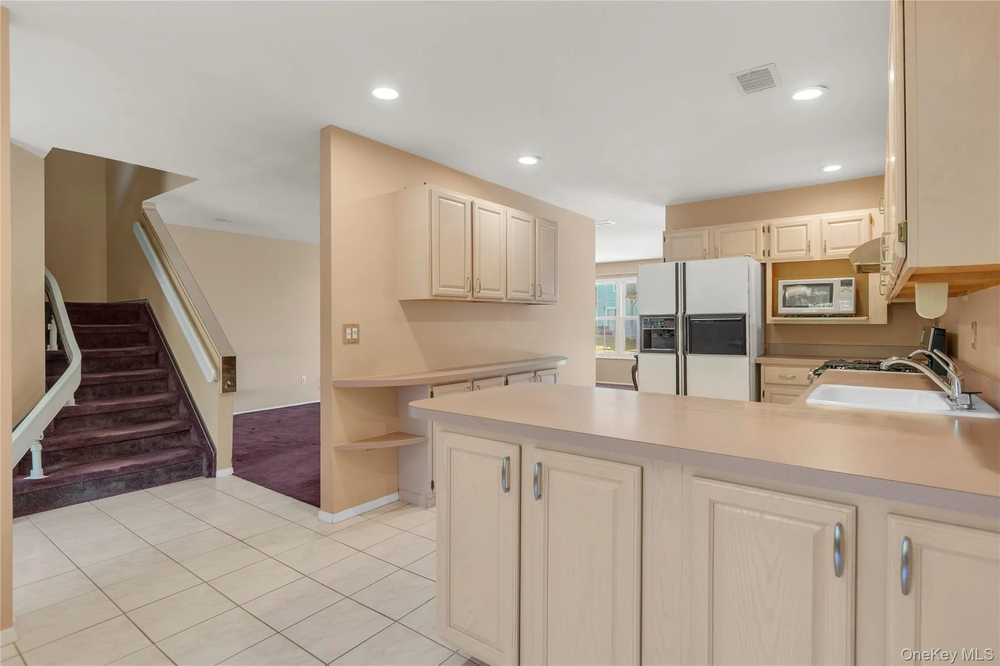 Kitchen featuring wood-finish cabinetry, integrated oven, and a built-in microwave Kitchen featuring wood-finish cabinetry, integrated oven, and a built-in microwave