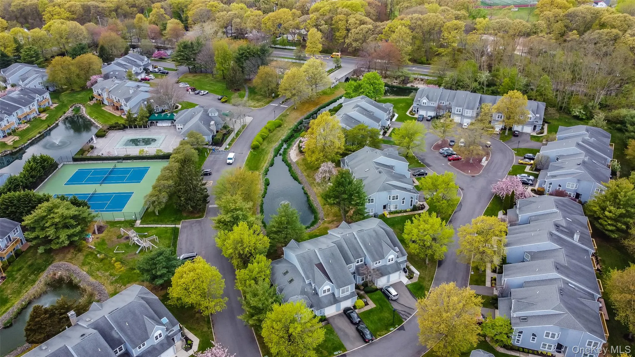 Aerial perspective showcasing a residential community with abundant mature trees and various architectural styles Aerial perspective showcasing a residential community with abundant mature trees and various architectural styles