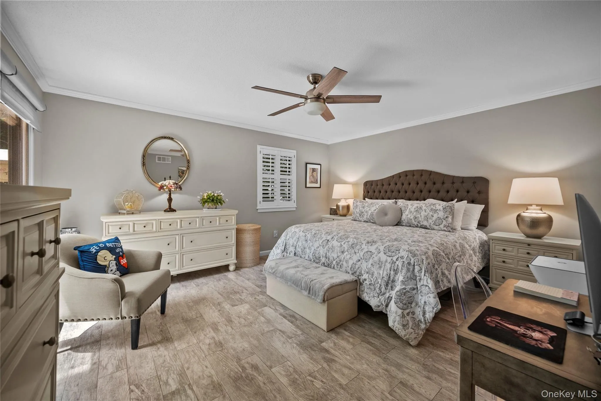 Spacious room featuring ceramic flooring, a ceiling fan, crown molding, and neutral wall tones Spacious room featuring ceramic flooring, a ceiling fan, crown molding, and neutral wall tones