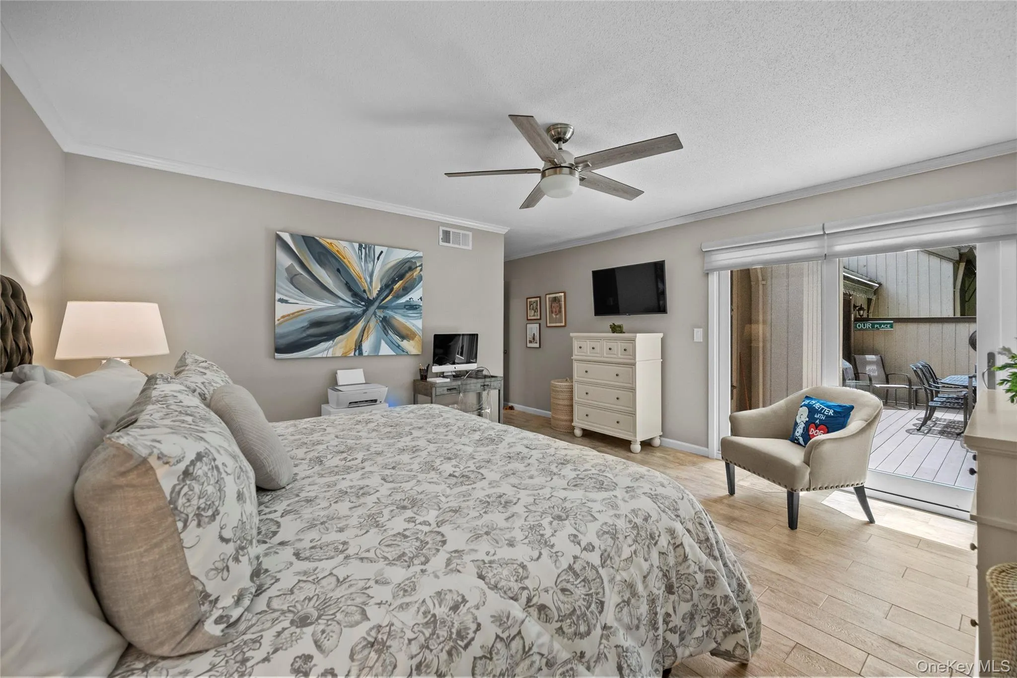 Bedroom with direct access to an outdoor deck through sliding glass doors Bedroom with direct access to an outdoor deck through sliding glass doors