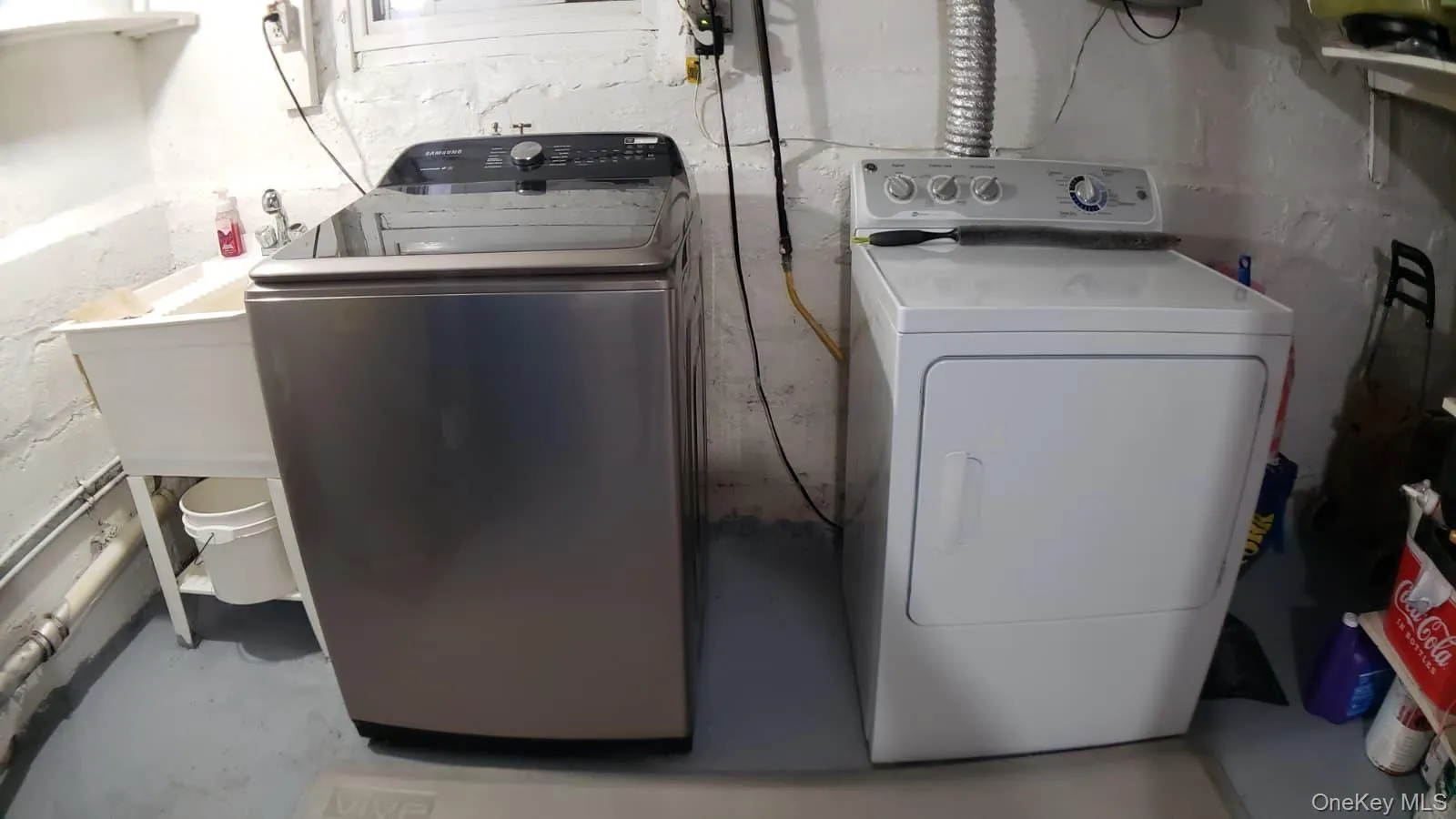 Laundry area with outside vented gas dryer. Laundry area with outside vented gas dryer.