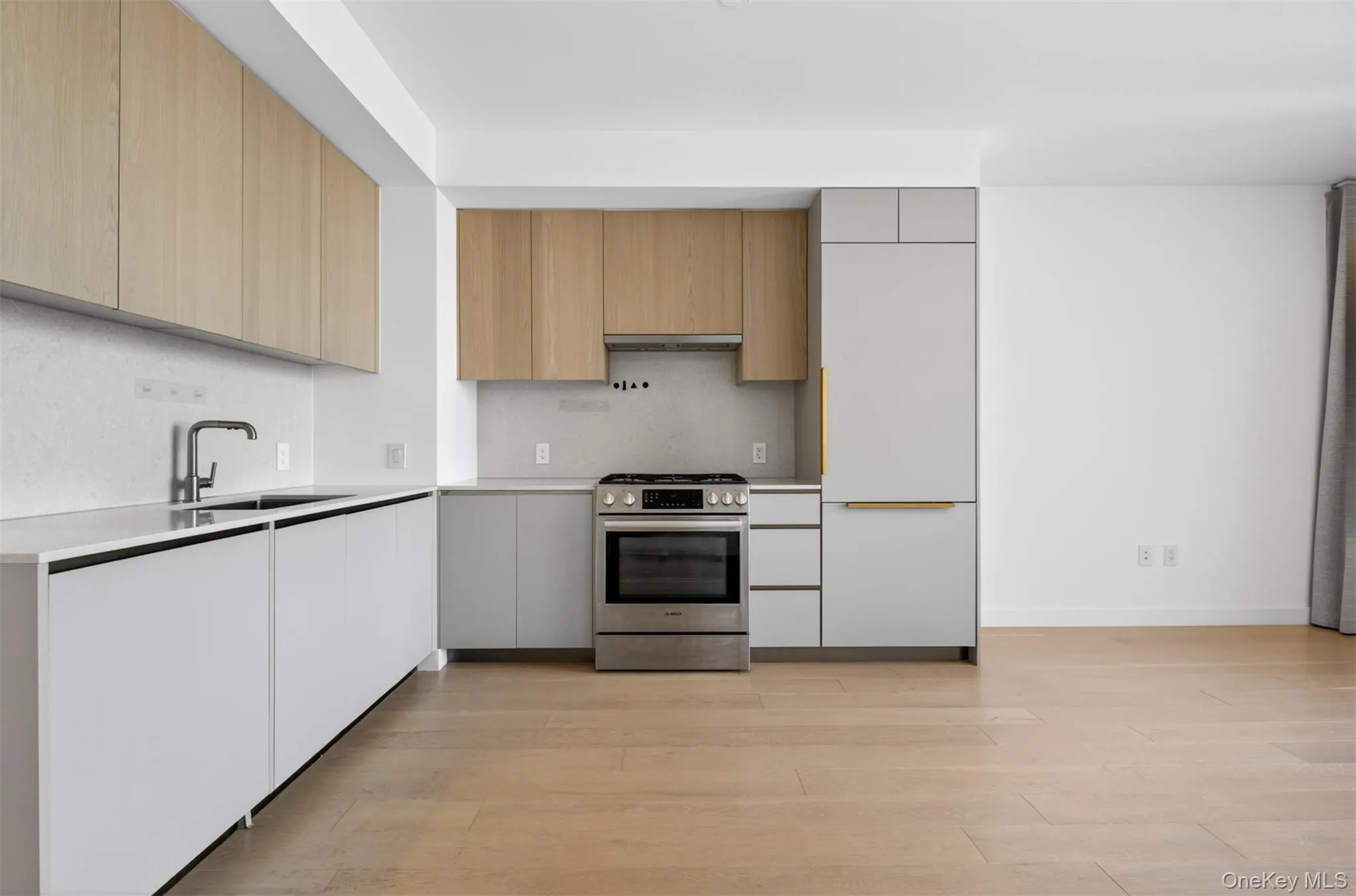 Modern kitchen with light wood-finish upper cabinetry and white lower cabinetry Modern kitchen with light wood-finish upper cabinetry and white lower cabinetry