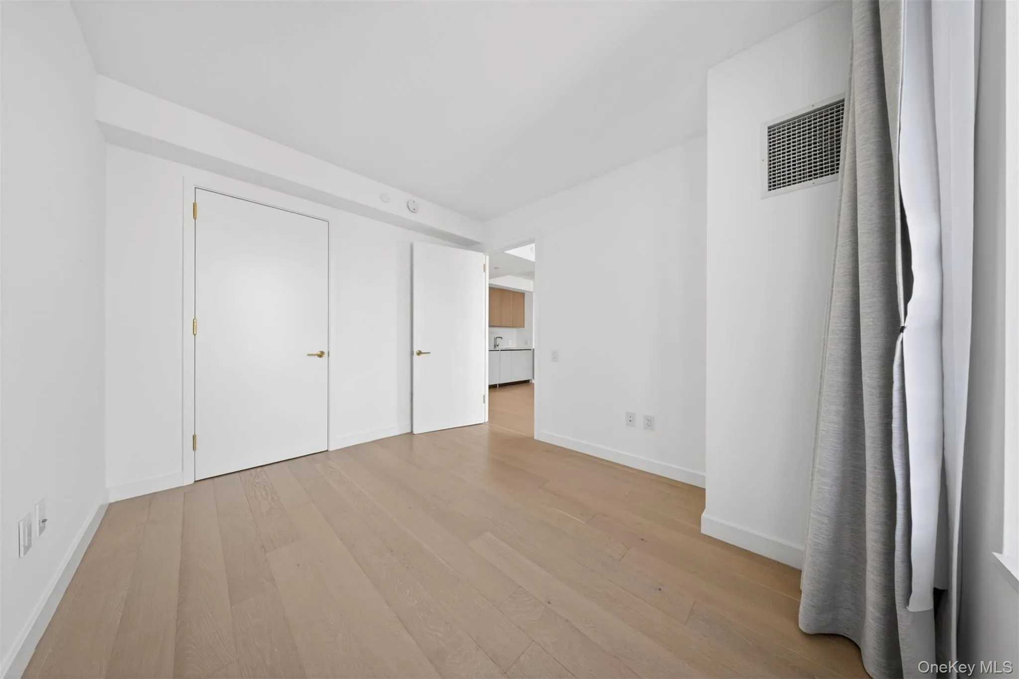 Light wood-finish flooring complements white walls and trim throughout this room Light wood-finish flooring complements white walls and trim throughout this room