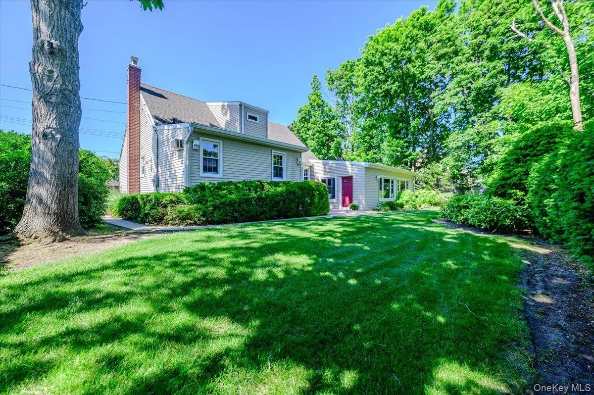 Expansive green lawn with mature trees and established perimeter shrubbery Expansive green lawn with mature trees and established perimeter shrubbery