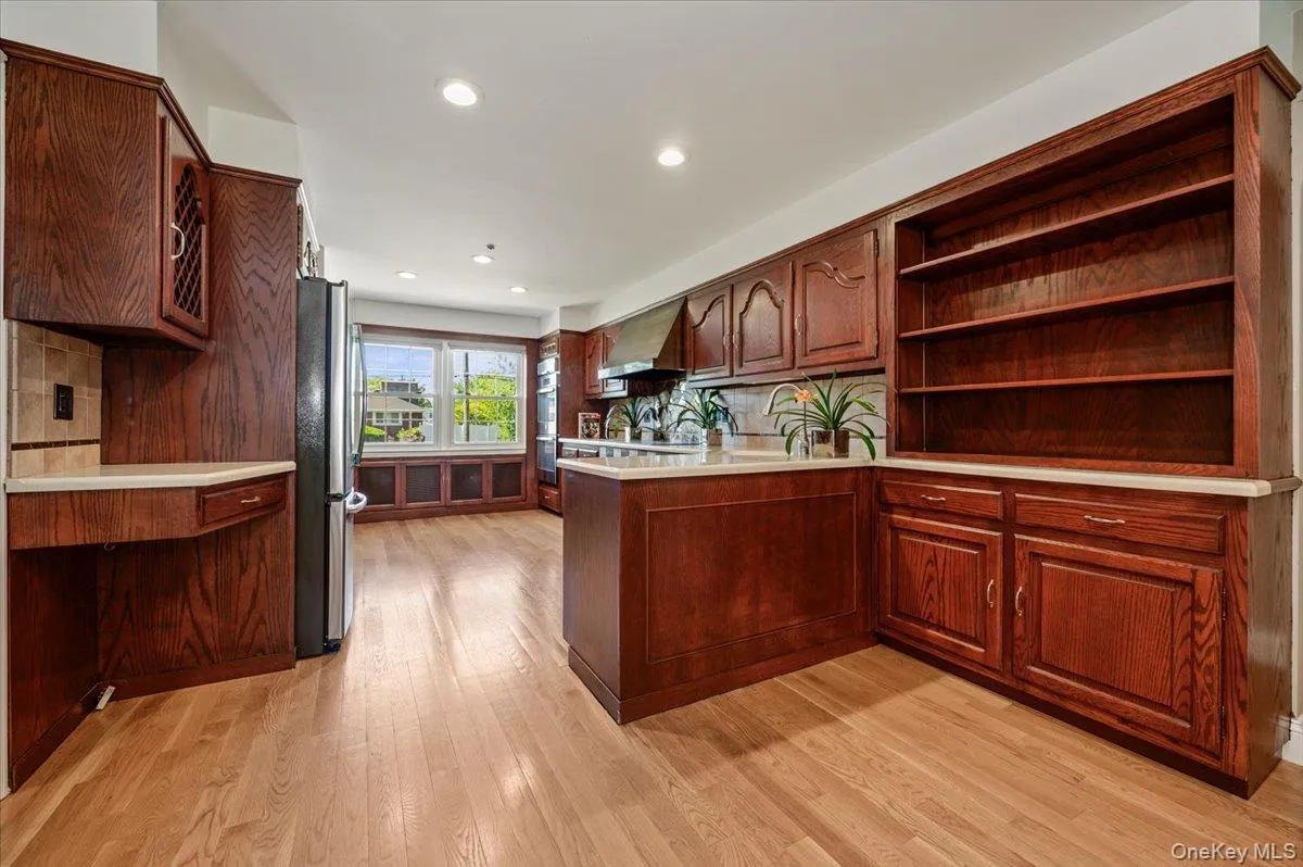 Large, bright space with wood cabinetry, stone countertops and tile backsplash. Hardwood flooring, recessed lighting and stainless steel appliances. Large, bright space with wood cabinetry, stone countertops and tile backsplash. Hardwood flooring, recessed lighting and stainless steel appliances.