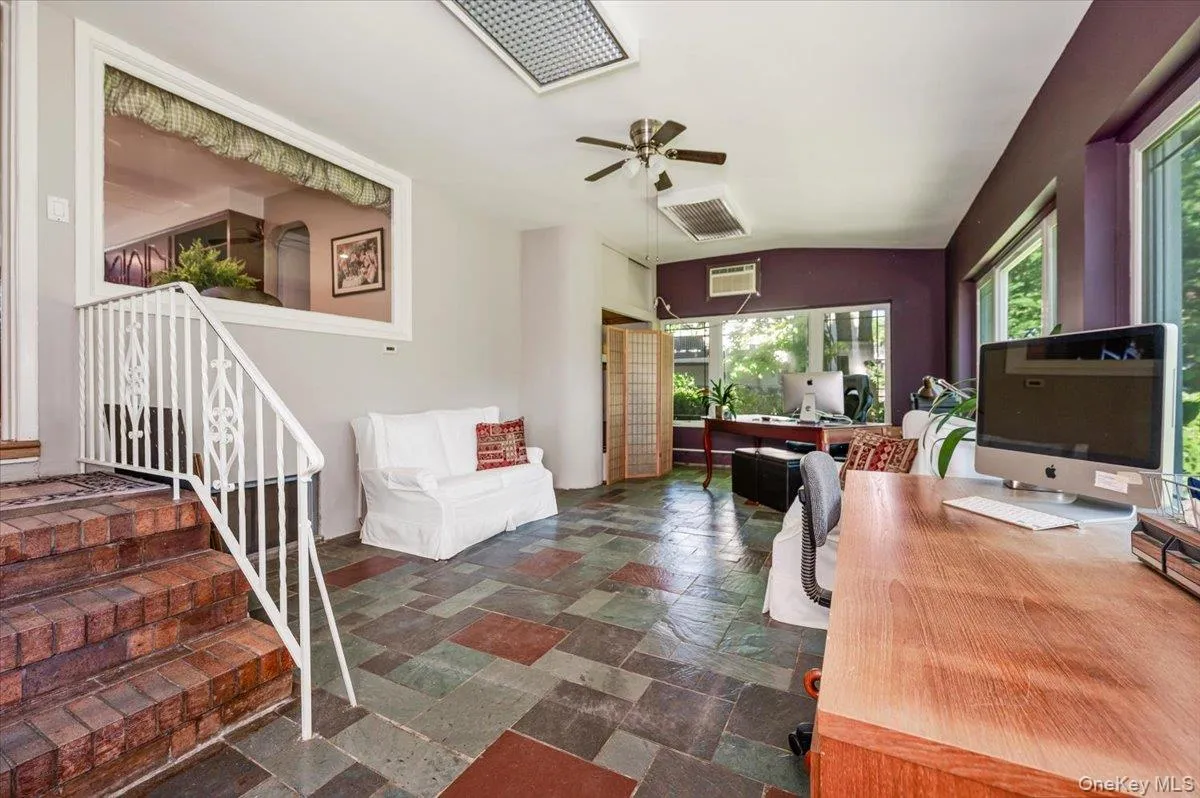 Closed in sunroom directly off of the kitchen with stone tile flooring and plenty of windows. Closed in sunroom directly off of the kitchen with stone tile flooring and plenty of windows.