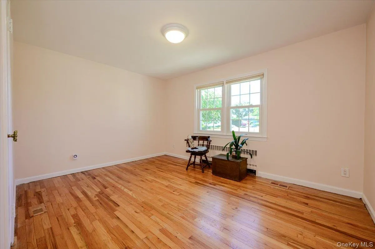 Second bedroom on main level with hardwood flooring and baseboard moldings. Second bedroom on main level with hardwood flooring and baseboard moldings.