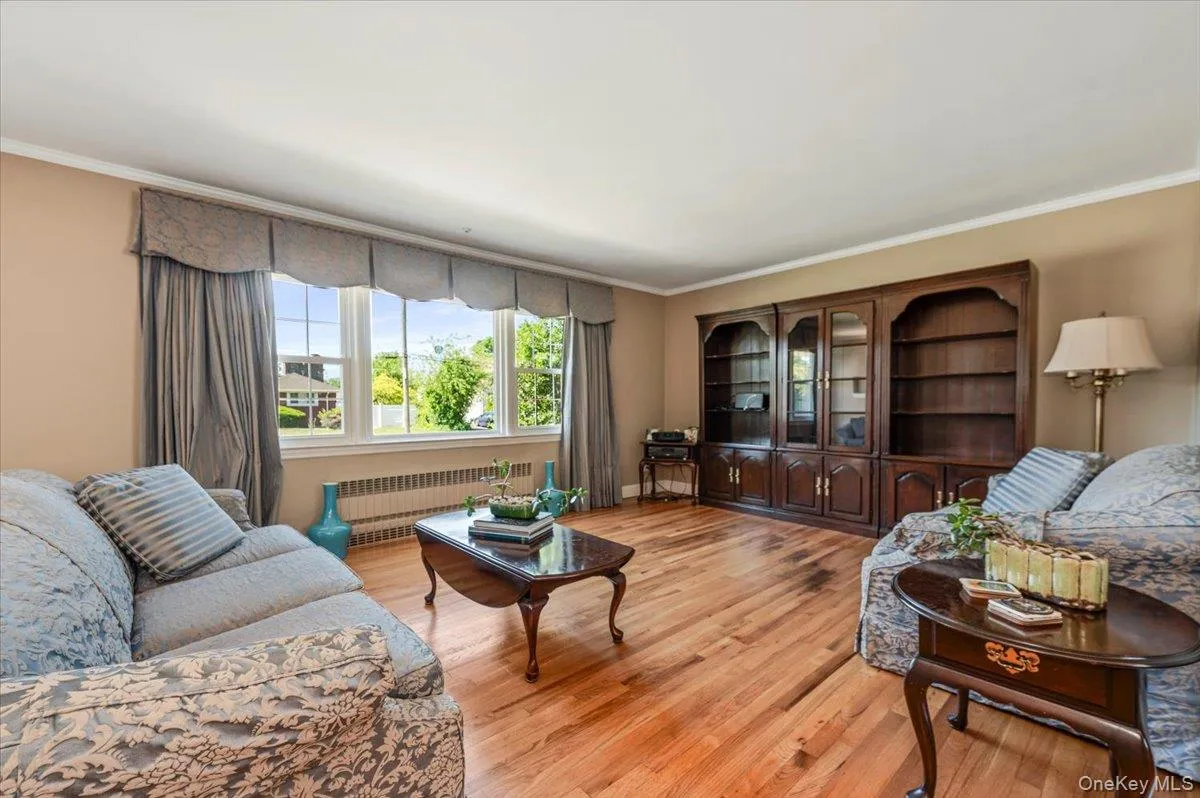 Hardwood flooring, crown molding and baseboard moldings, and large picture window. Hardwood flooring, crown molding and baseboard moldings, and large picture window.