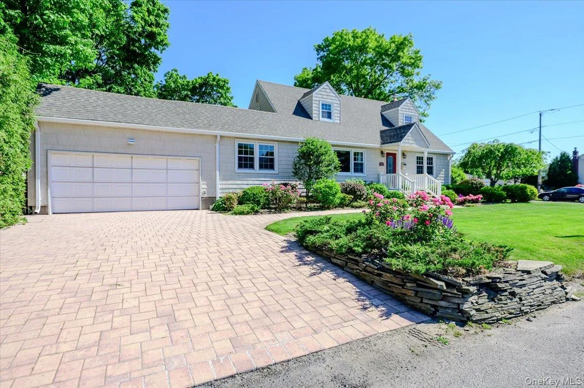 Attached two car garage with paver driveway. Attached two car garage with paver driveway.