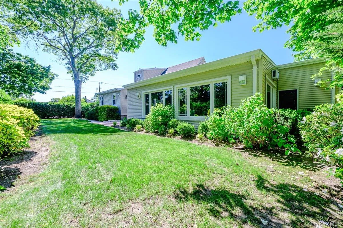 Grassy area with mature landscaping. Grassy area with mature landscaping.