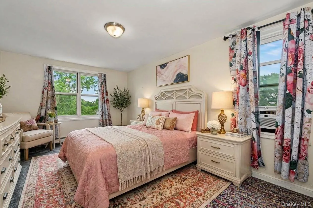 Spacious room featuring light-colored walls, a large window, a ceiling-mounted light fixture, and carpeted flooring. Virtually Enhanced. Spacious room featuring light-colored walls, a large window, a ceiling-mounted light fixture, and carpeted flooring. Virtually Enhanced.