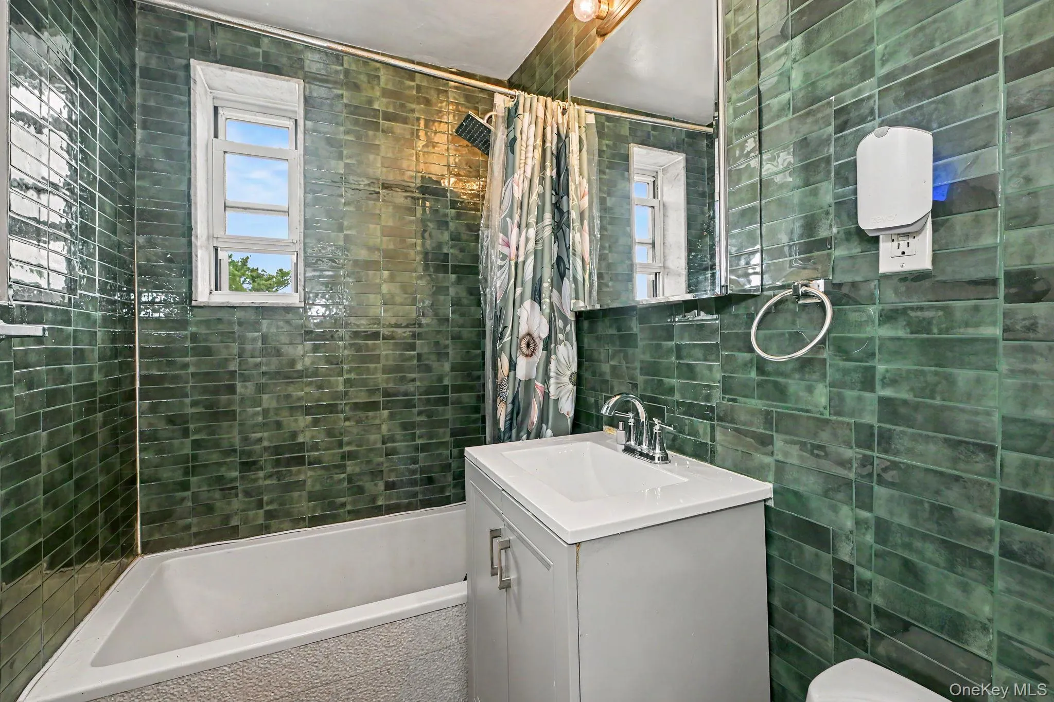 Bathroom featuring a white vanity with a rectangular sink, chrome faucet, and integrated storage Bathroom featuring a white vanity with a rectangular sink, chrome faucet, and integrated storage