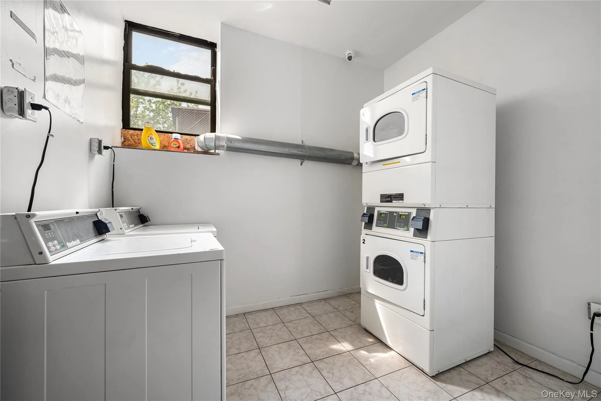 Dedicated laundry area featuring commercial-grade washers and dryers Dedicated laundry area featuring commercial-grade washers and dryers